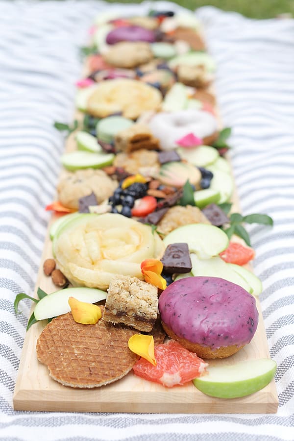 Long wooden board with cookies and treats