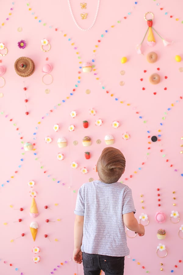 Little boy looking at a wall of desserts at the Museum of Ice Cream