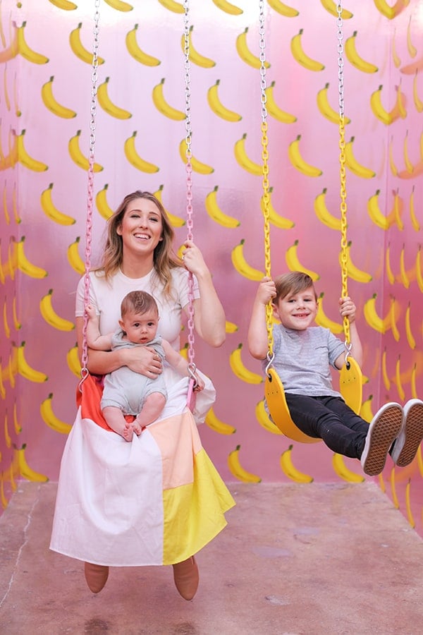 Eden Passante and kids swinging on a swing at the museum of ice cream.