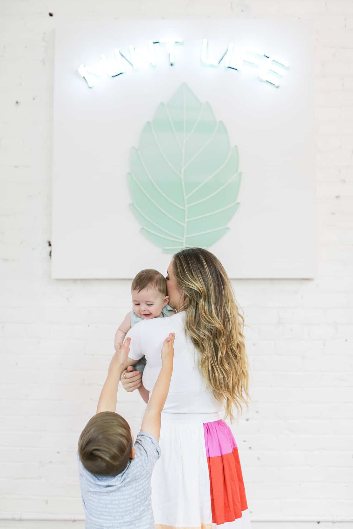 Eden Passante holding baby at the museum of ice cream