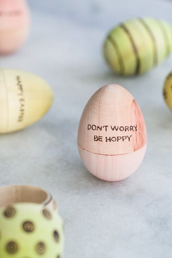 A pink Easter egg that says Don't worry be hoppy on it.