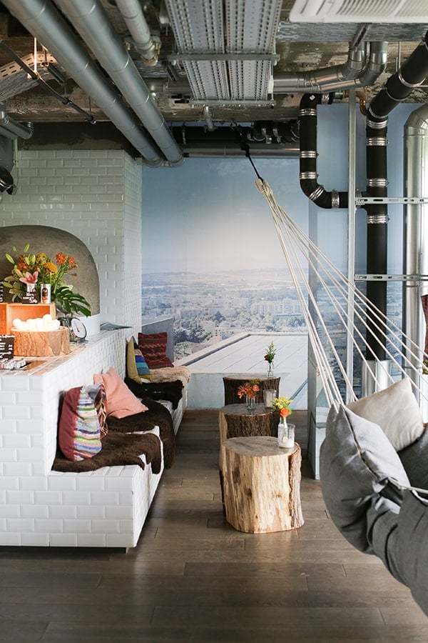 Mural, wooden stumps and a hammock in a cafe.