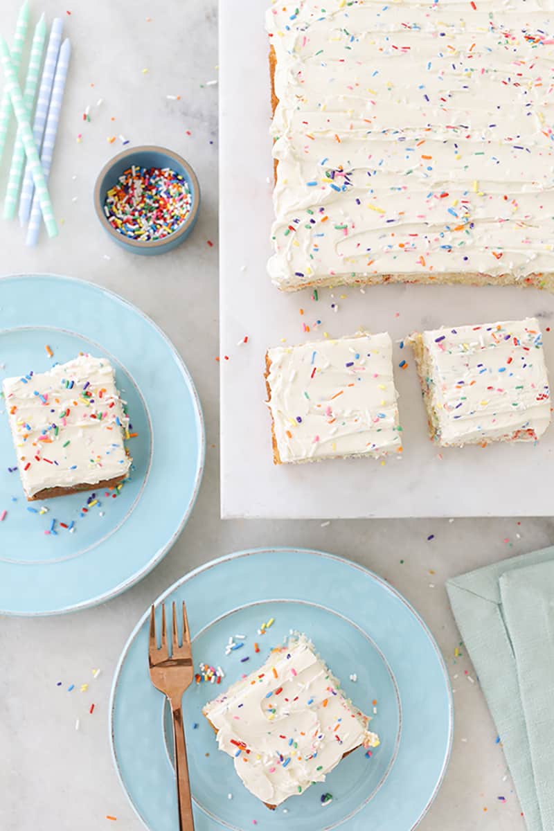 Homemade funfetti cake sliced with sprinkles and candles. 