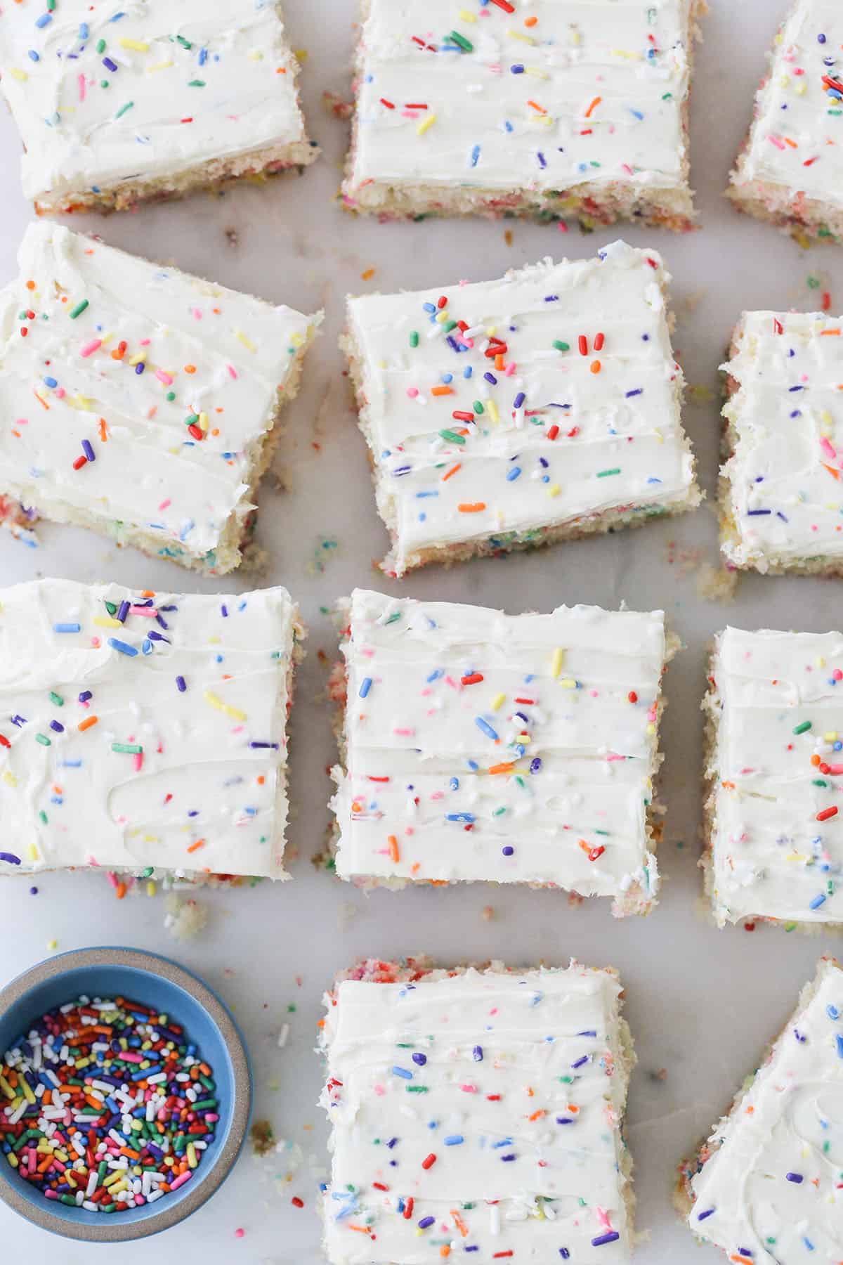 Slice of a confetti cake with colorful sprinkles. 