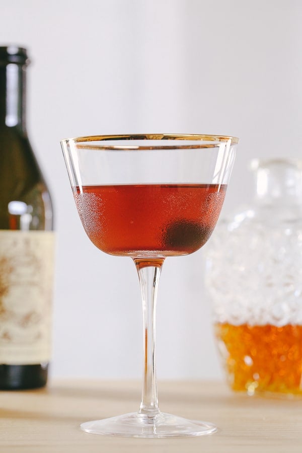 Manhattan cocktail in a coupe glass with a cherry. 