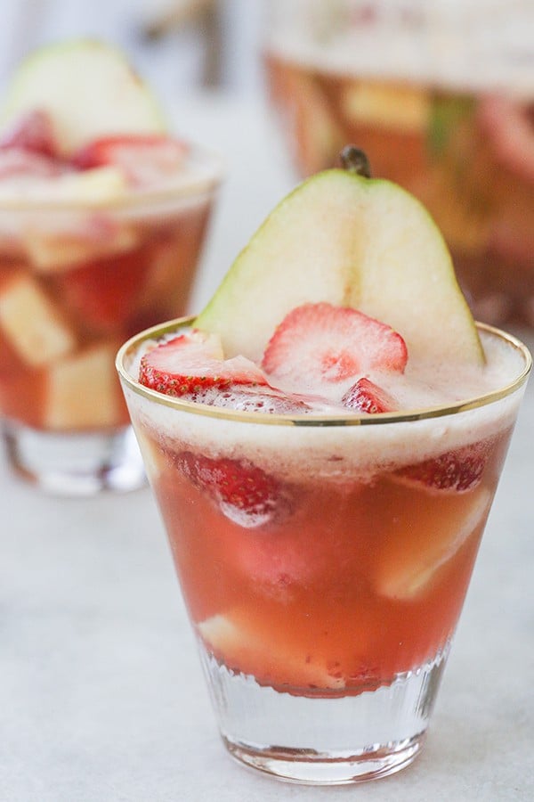 Sherbet punch in a glass with sliced pear and strawberry 