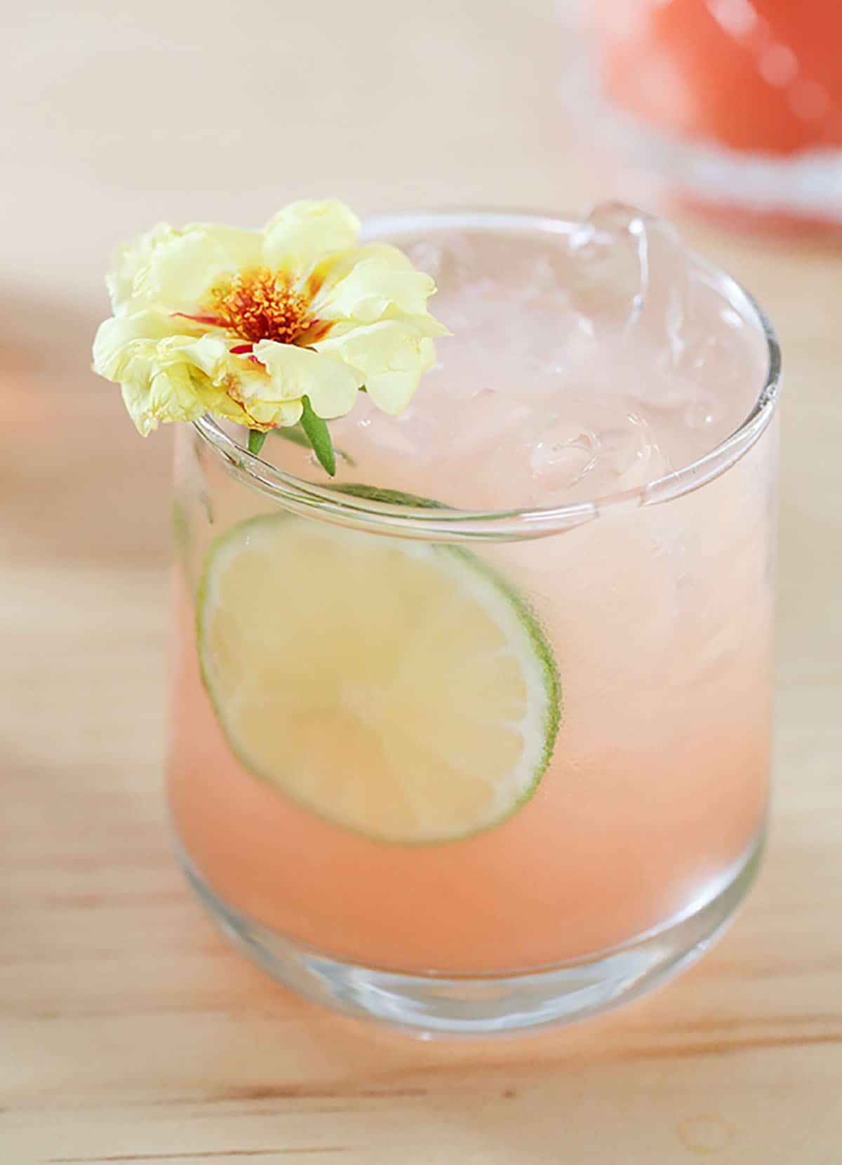 a cocktail garnish with flower - paloma cocktail recipe - fresh grapefruit juice