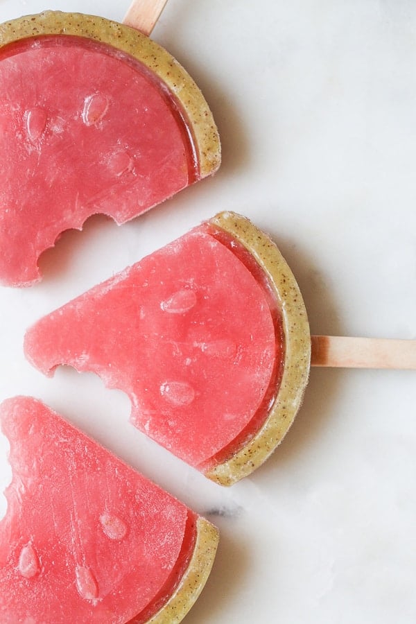 Watermelon popsicles in the shape of watermelon slices with a kiwi rind.
