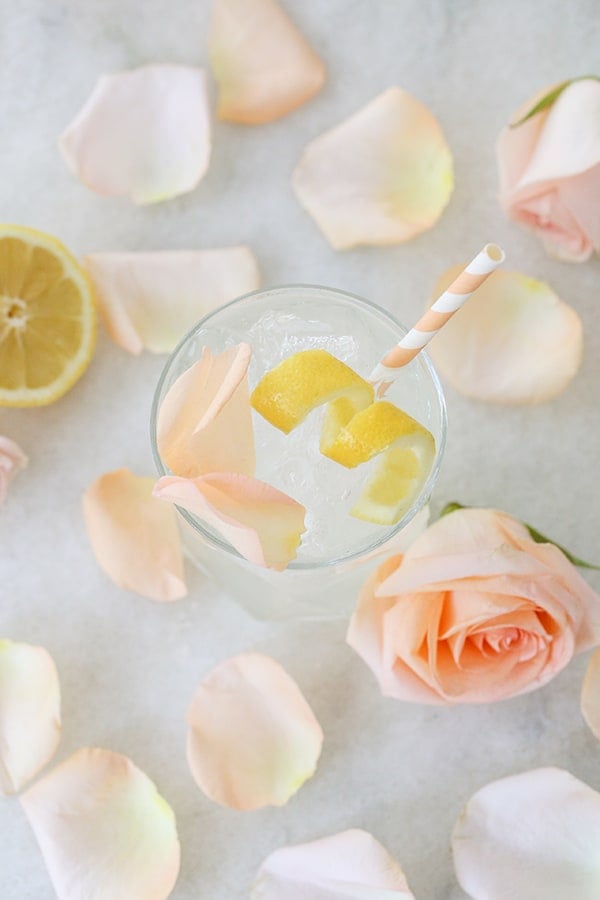 Rose water Cocktail with Lemon Wedge and rose petals 
