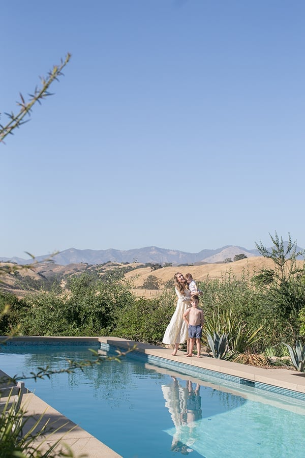 Eden Passante standing by a pool with her two boys in Los Olivos