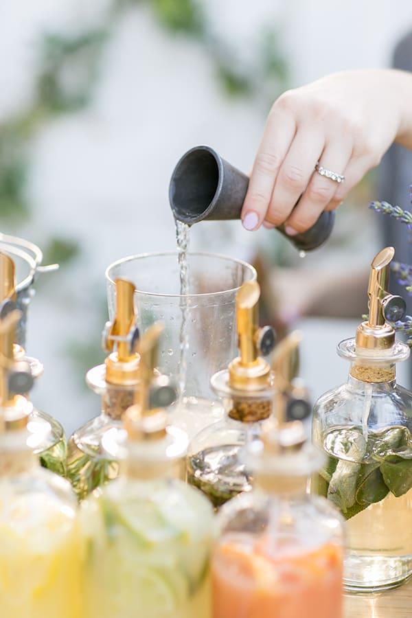 Pouring a spirit into a cocktail shaker.