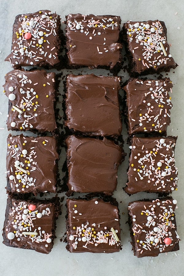 Chocolate Zucchini Cake with chocolate buttercream frosting and sprinkles cut into squares