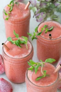 strawberry frose in glasses with fresh herbs.