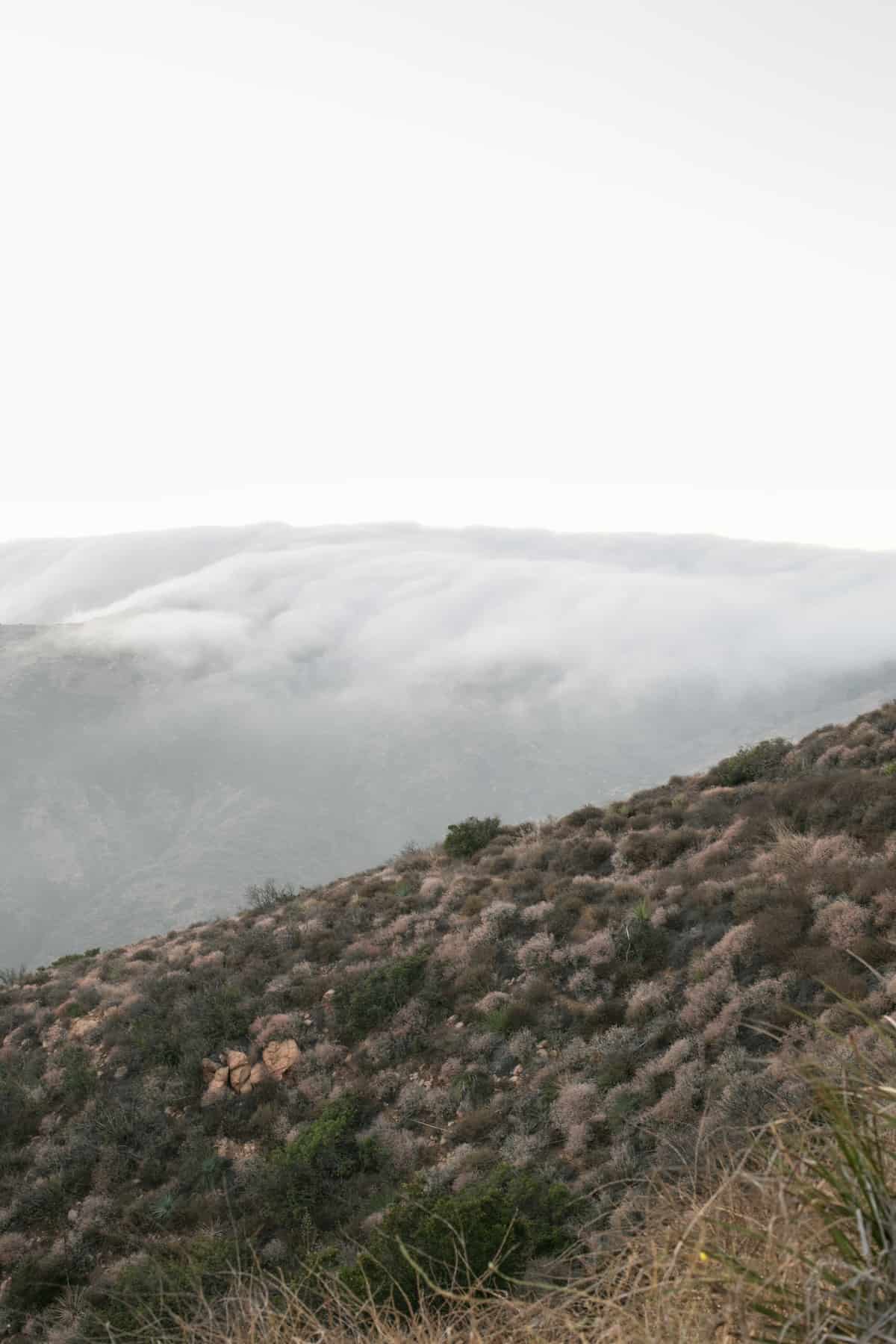 Clouds rolling over a mountain