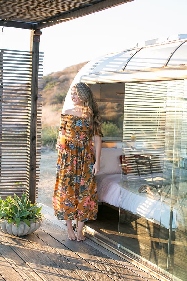 Eden Passante standing in front of an Airstream in Malibu. 