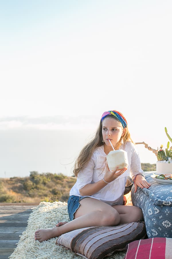 Girl drinking out of a coconut in Malibu.