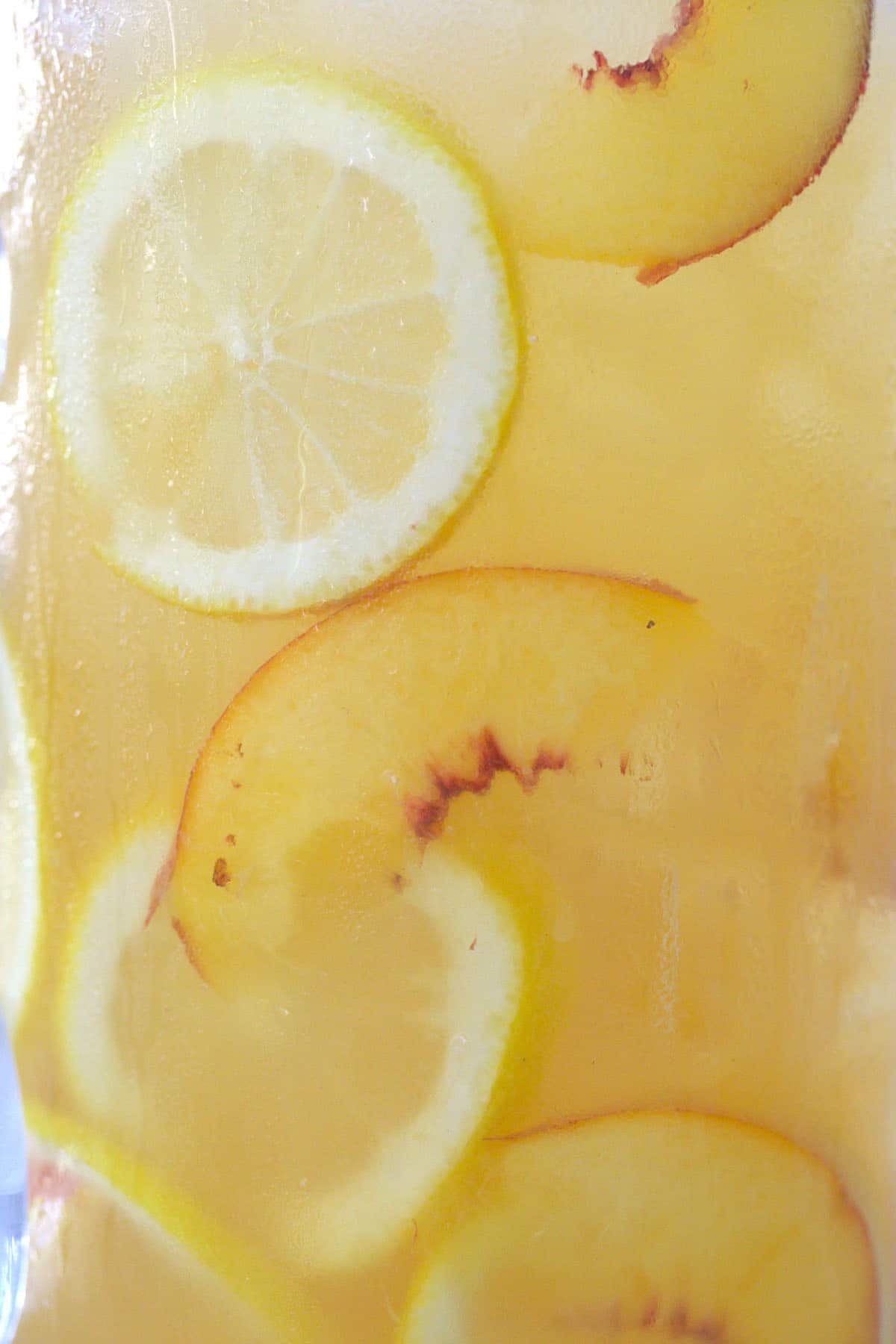 lemons and peaches in a pitcher