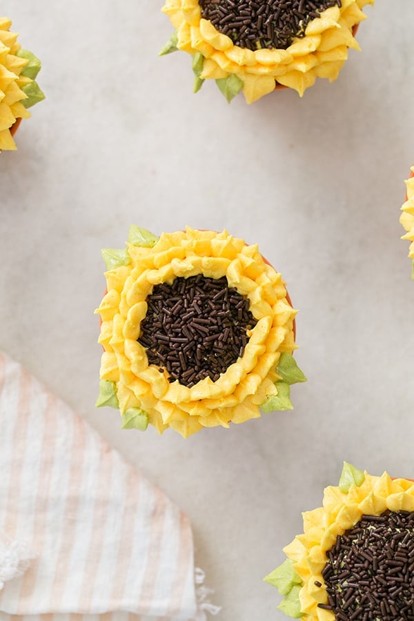 Pumpkin Spice Sunflower Cupcakes on a marble table