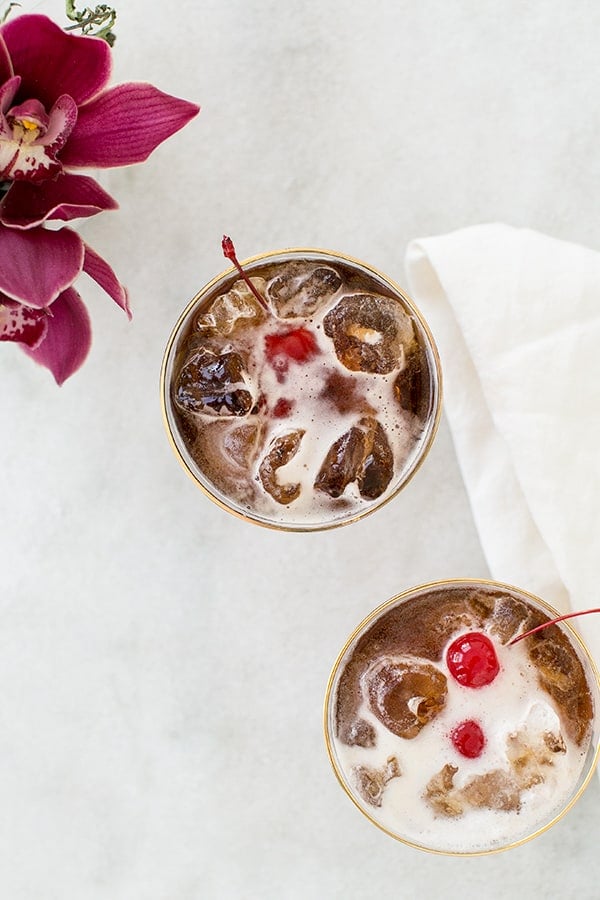 Coffee tonic recipe with a cherry and filled with ice 