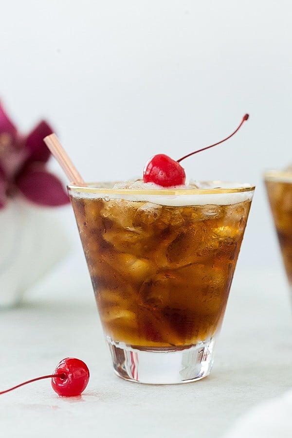 Coffee tonic with a red cherry.