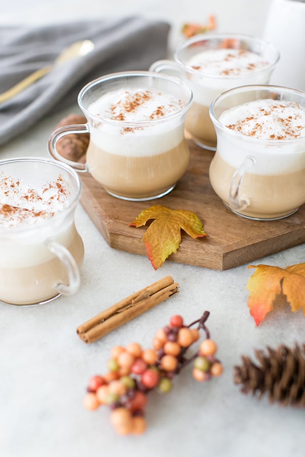 French vanilla coffee in a glass mug with cinnamon sticks.