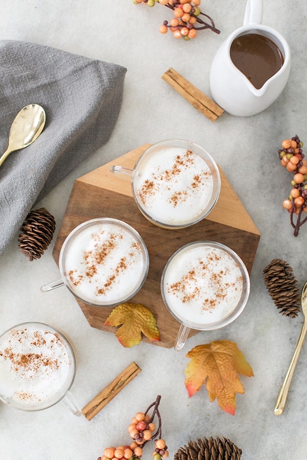 Vanilla lattes on a wooden board with falls leaves. 