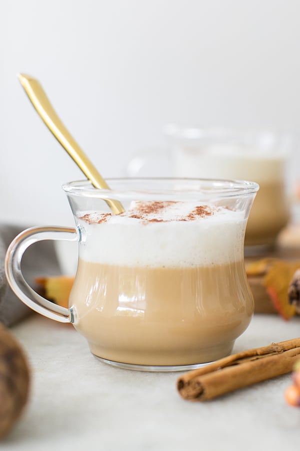 French vanilla coffee with caramel and frothy milk in a clear glass mug. 