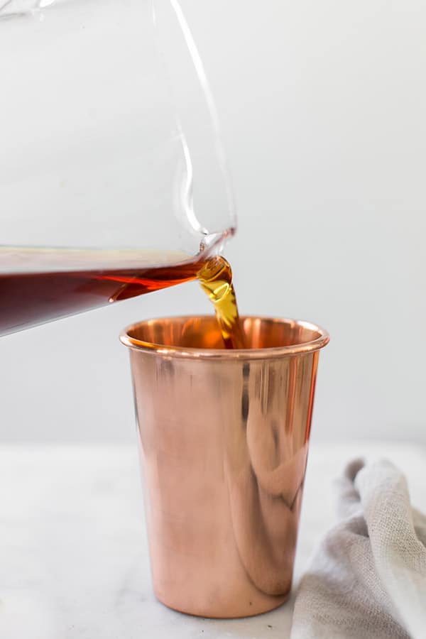 shot of coffee being poured into a mug