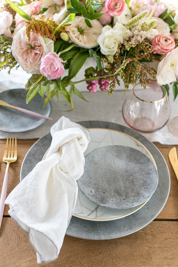 shot of flowers and a plate setting on the table