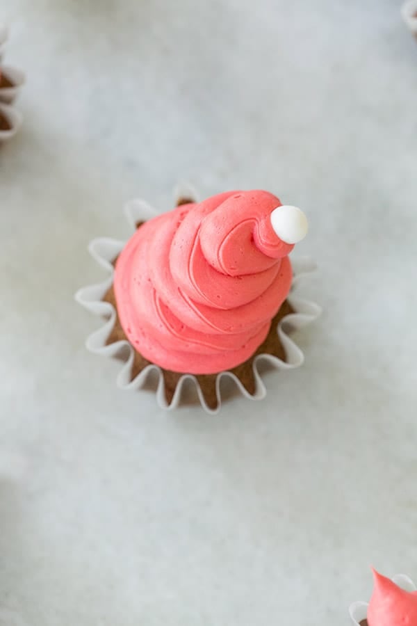 gingerbread cupcake with frosting on top.