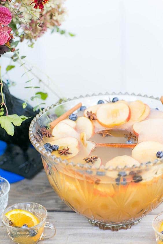 Spiked apple cider punch in a punch bowl with apple ice ring.