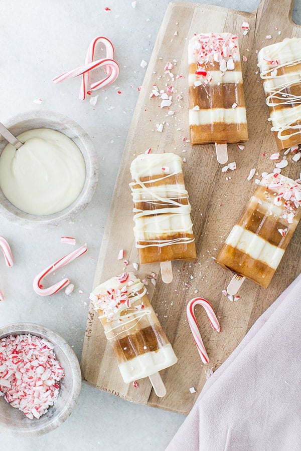 Striped popsicles with coffee and white chocolate with peppermint candy cane crushed over the top