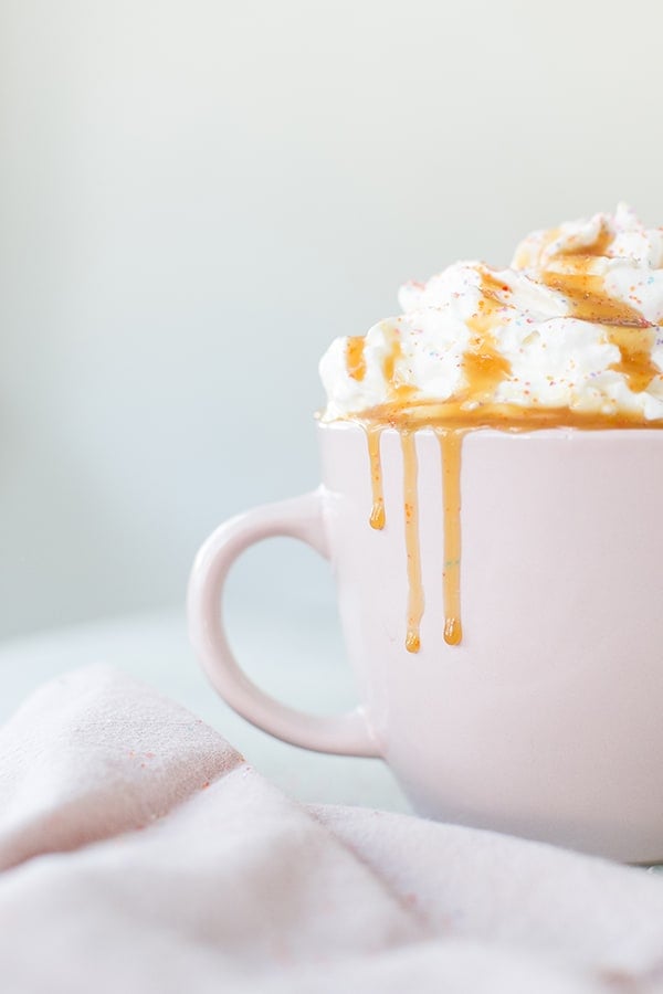 side shot of a cup with creme brûlée coffee in it