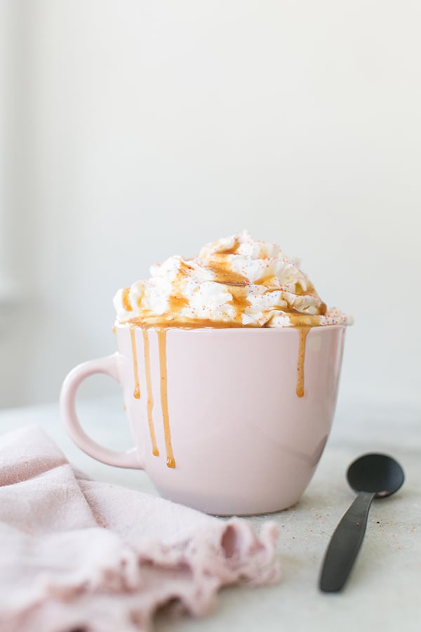 profile shot of creme brûlée coffee in a white mug