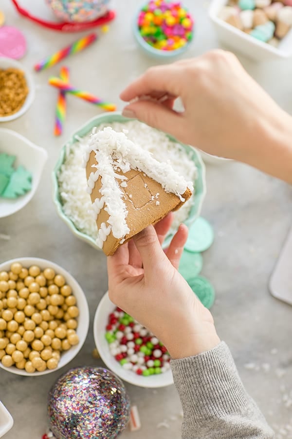 shot of diy gingerbread house roof being decorated - royal icing, muffin tins