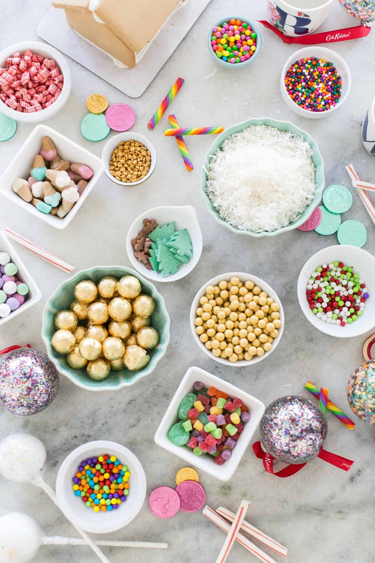 top down shot of table with candies on it for the diy gingerbread house party - gingerbread house decorating party