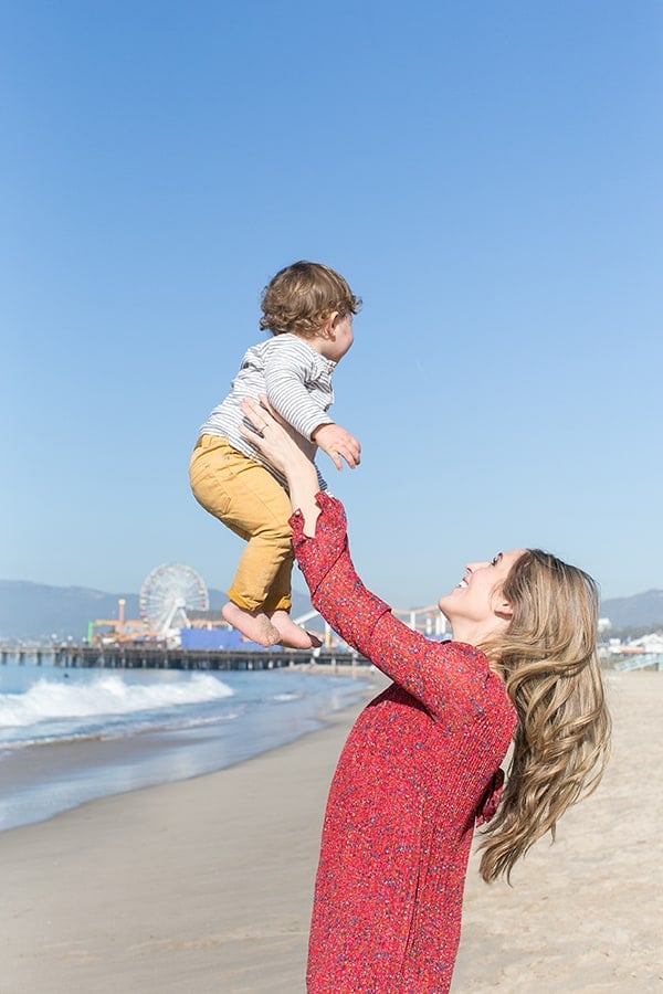 Eden Passante holds baby in Santa Monica on the beach. 