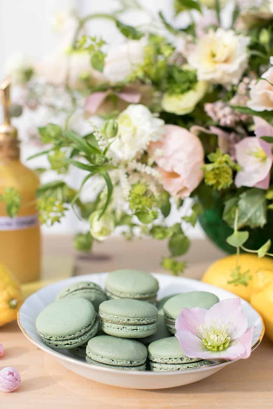 green macrons on a white bowl. 