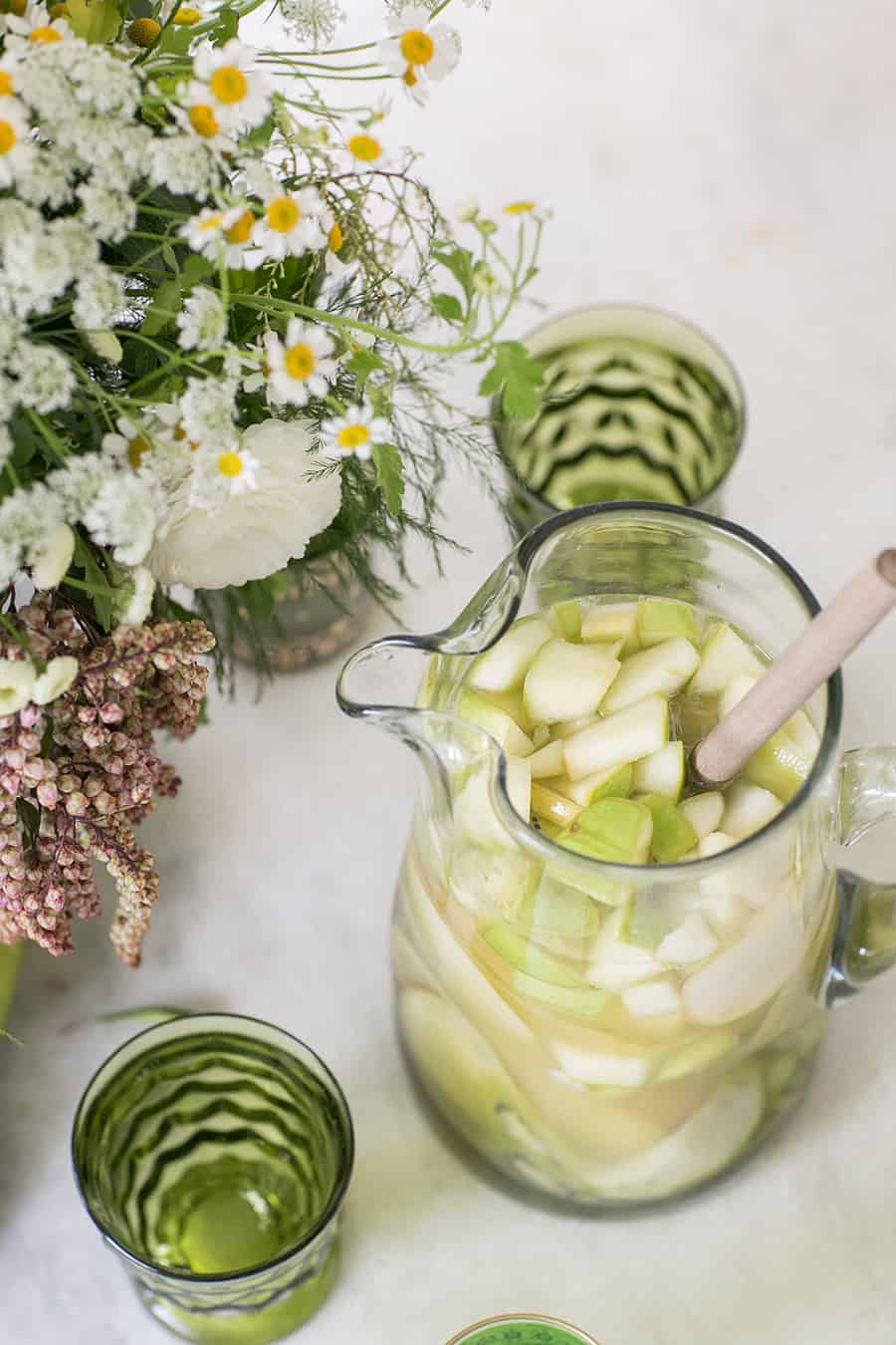 Green Irish Whiskey Sangria with sliced apples, pears, grapes and other green fruit. 