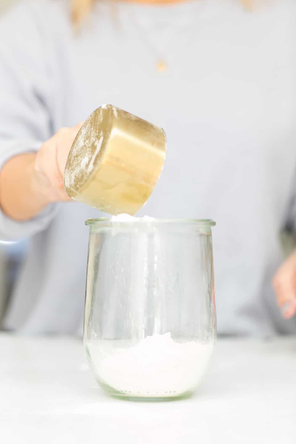 pouring flour into a jar