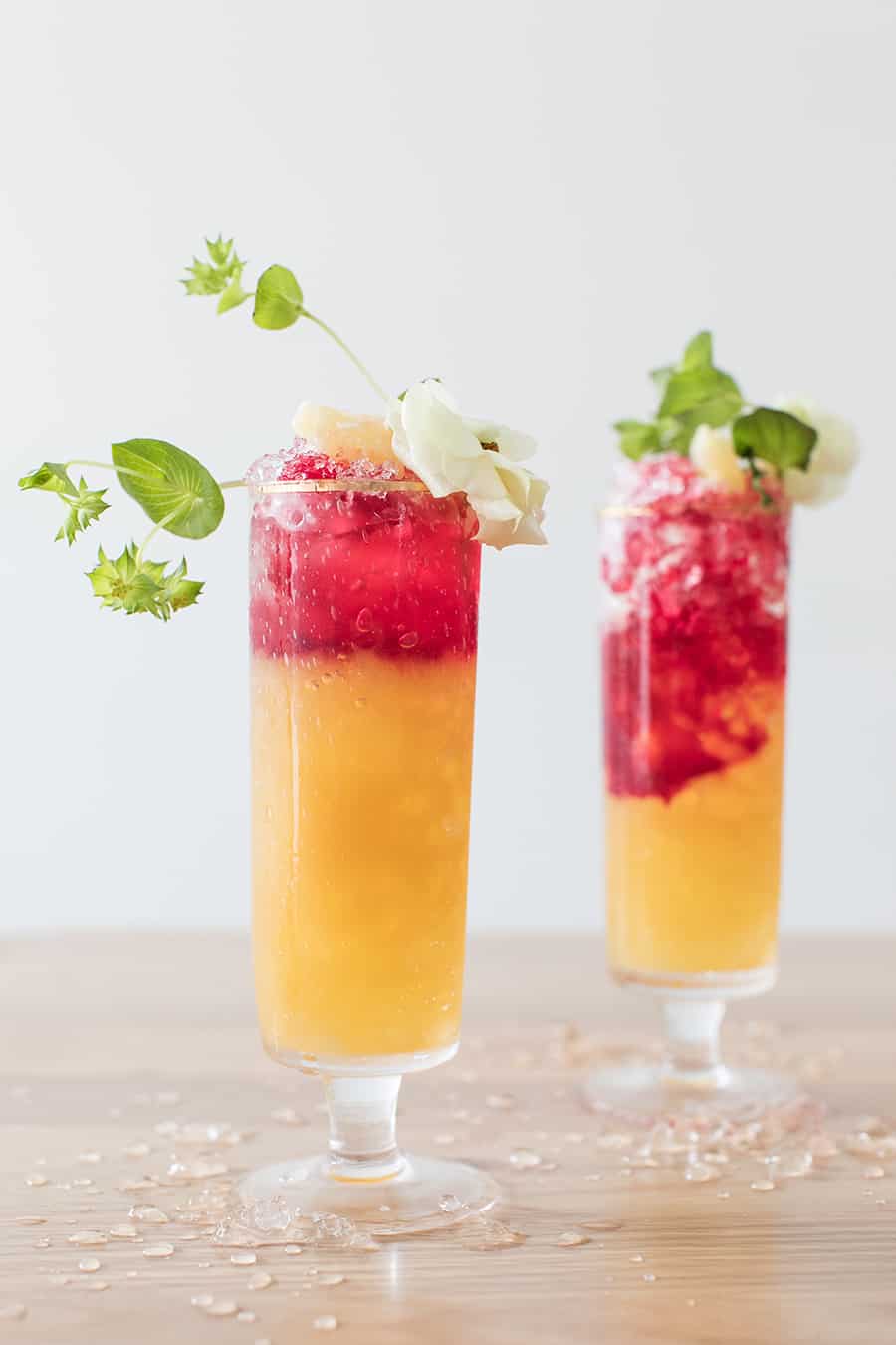 Pineapple tequila cocktail with beet juice and flowers