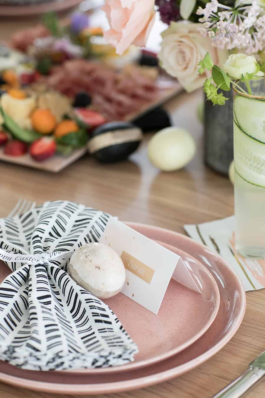 Pink plates with a name card and a marble Easter Egg