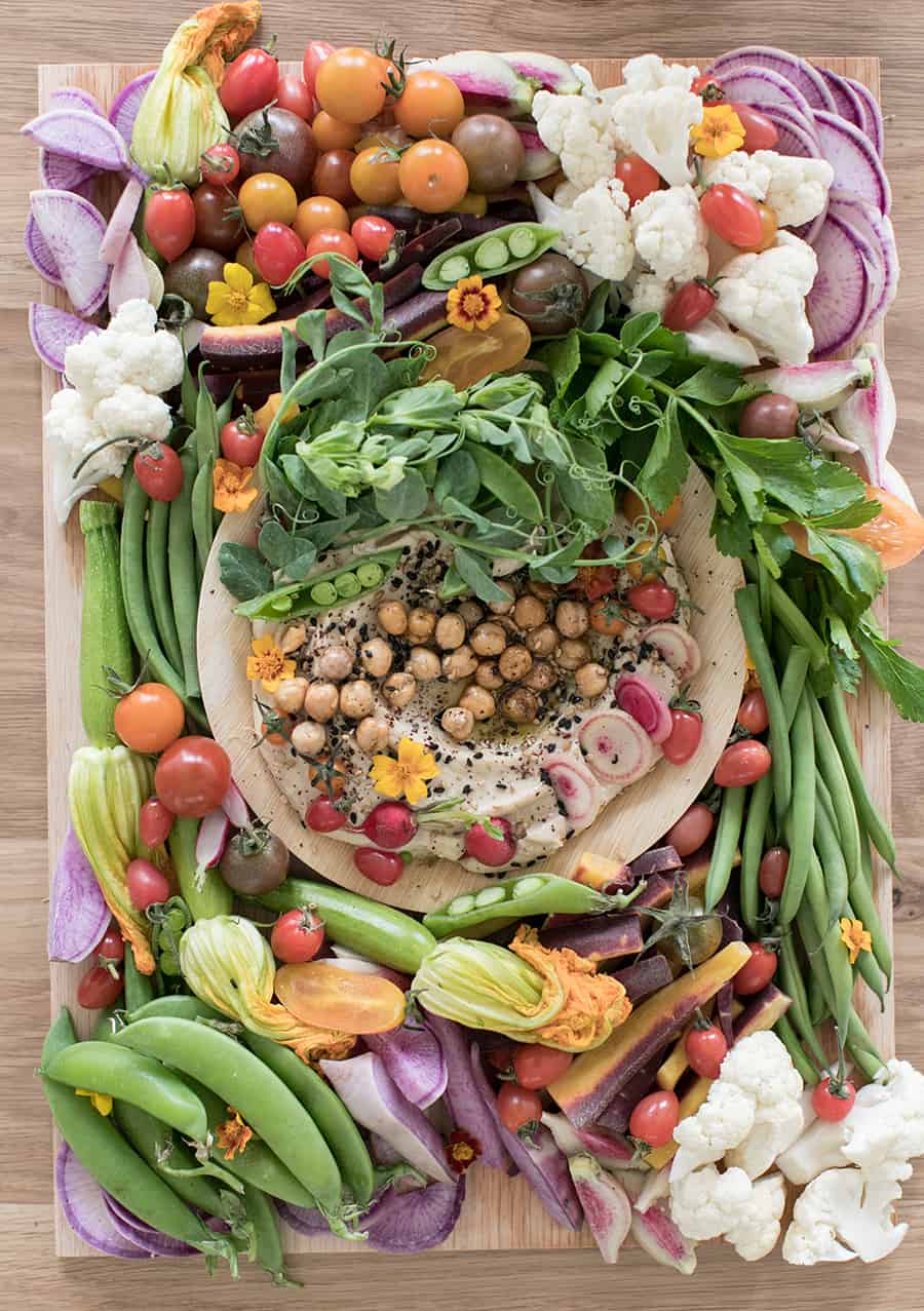 Vegetable platter with hummus and colorful vegetables.