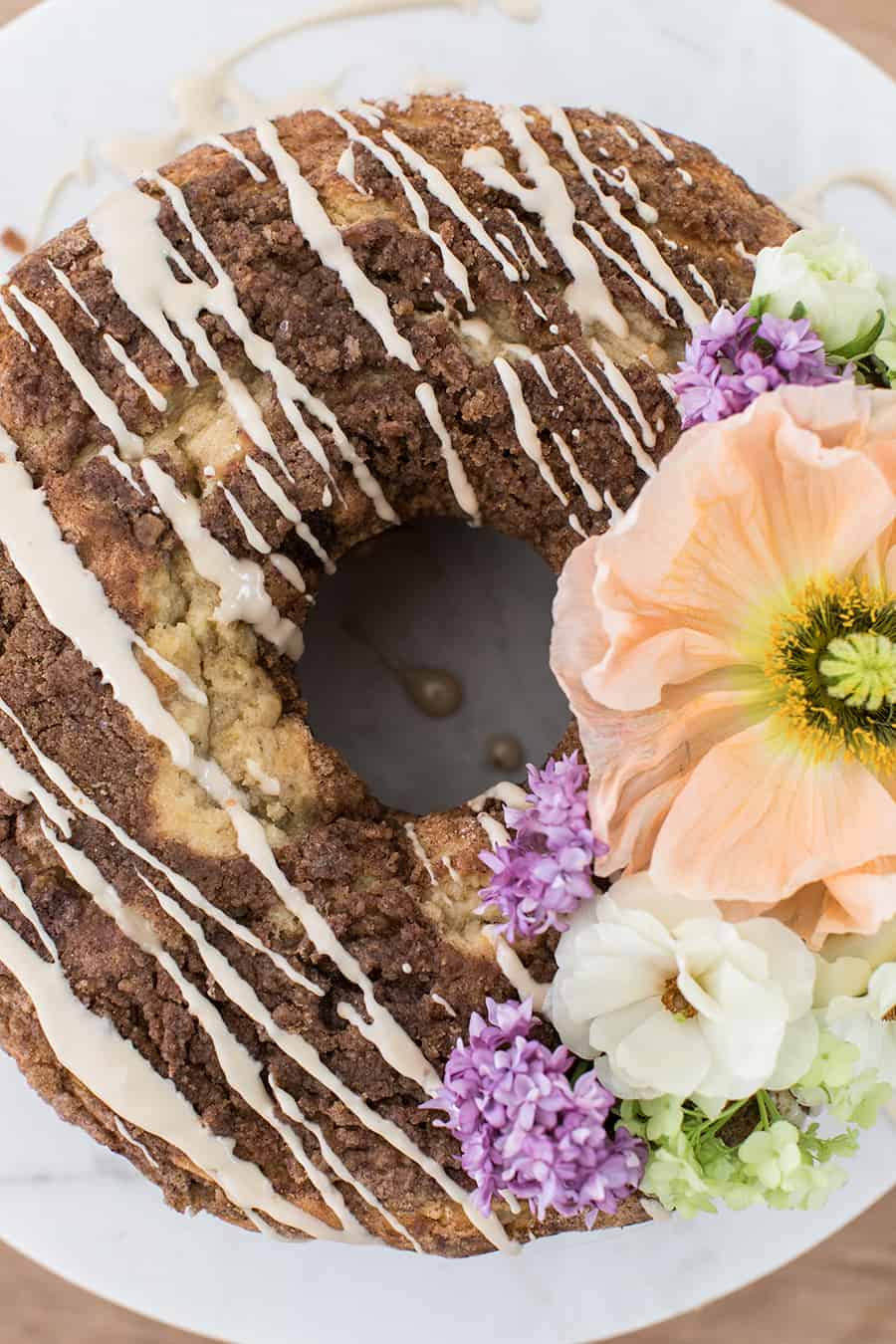 Coffee cake for brunch with glaze and flowers.