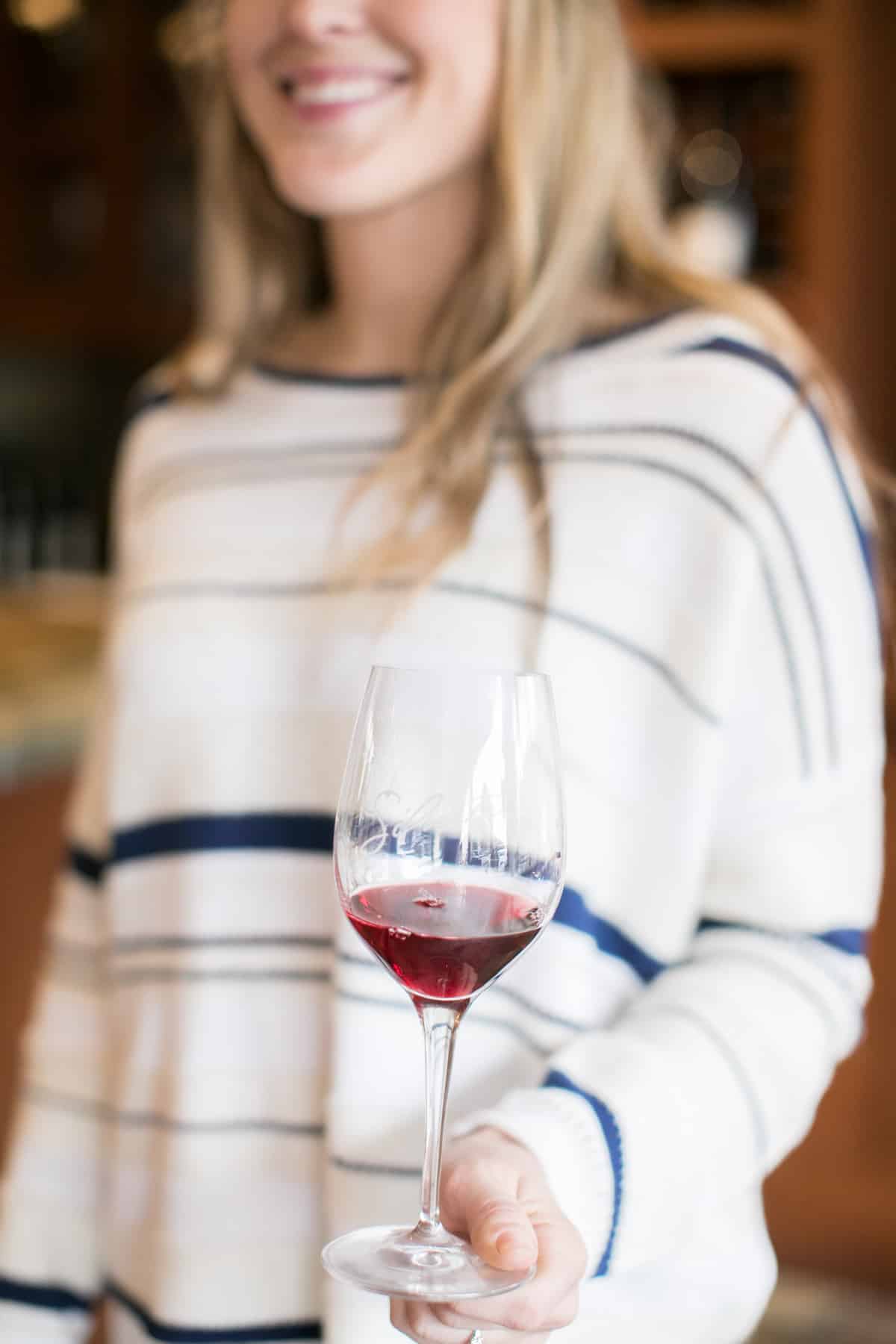 Girl holding a glass of red wine