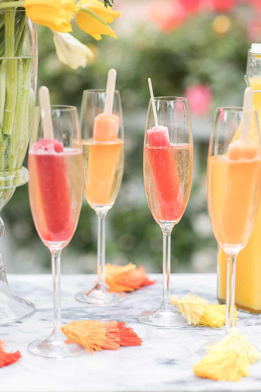 Popsicles in glasses filled with Champagne