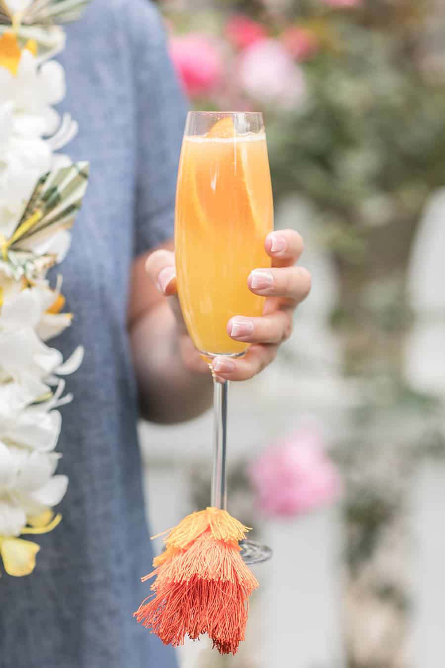 Holding a mimosa with a colorful tassel