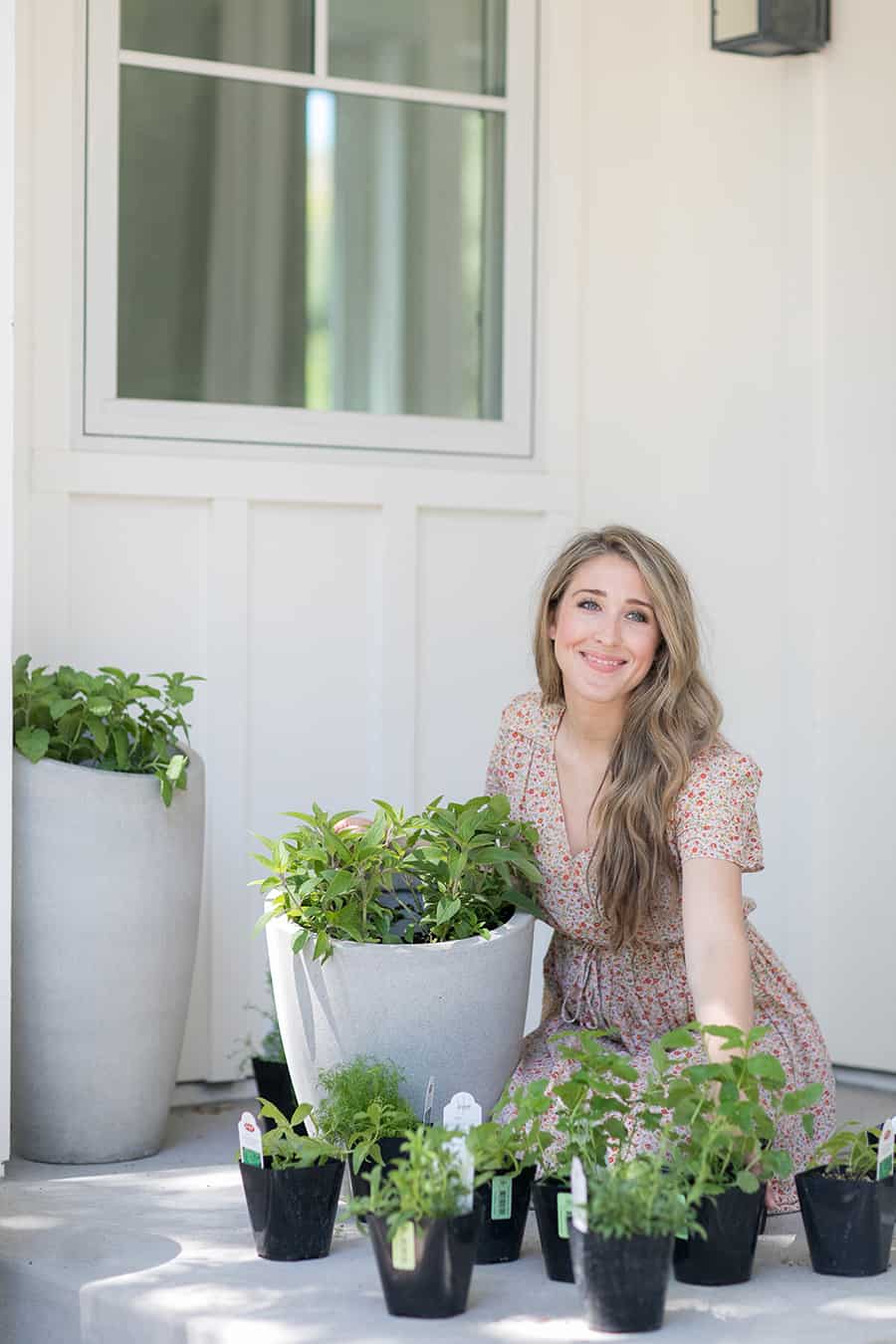 Eden Passante planting herbs on her side porch.