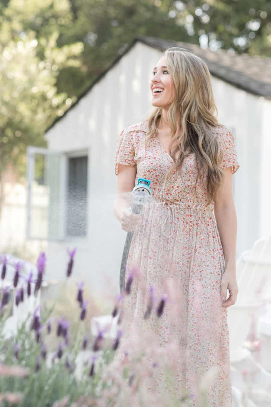 Eden Passante watering plants and herbs.