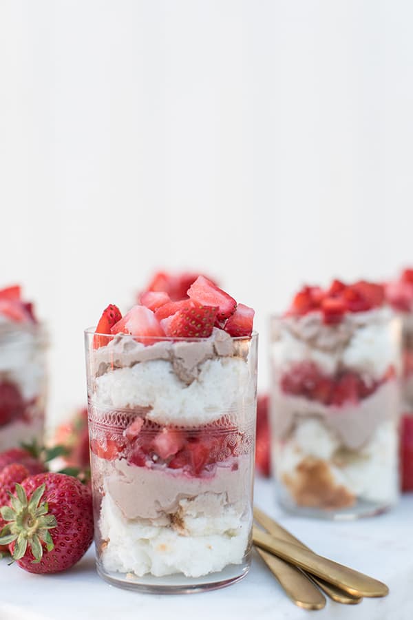 Layered angel food cake with chocolate whipped cream and strawberries. 